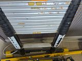 a fork lift with a yellow sign on the side of it