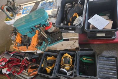 a pile of tools sitting on the floor next to a box