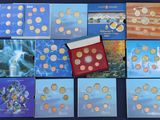 several different types of coins are displayed on a table