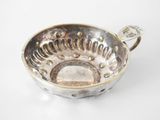 an image of a silver cup on a white surface