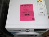a white washing machine with a pink label on it