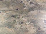 a picture of a painting of a beach with rocks in the water