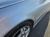 a silver car that is parked on the side of the road