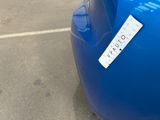 a sticker on the back of a blue car