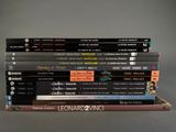a lot of books stacked on top of each other