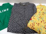 three women ' s clothing are lined up on a white table