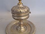 an antique silver plate with a lid on a white surface
