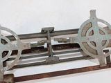 a metal object that is sitting on top of a wooden stand