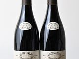 deux bouteilles de vin posées l'une à côté de l'autre sur une table en bois