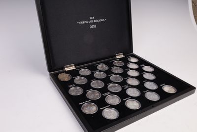 a black box with twelve coins in it on a table