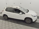 a white car parked in a garage with a checkered floor