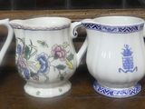 five vases sitting on a shelf in front of a window