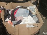 a cardboard box full of clothes sitting on a carton