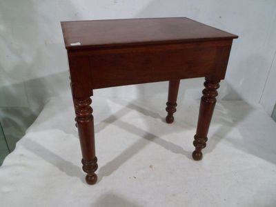 a small wooden table with a drawer on it