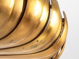 a gold sculpture of a shell on a white surface