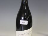 a bottle of wine sitting on a table with a label on it
