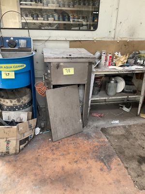 an image of a kitchen area with a trash can and a trash can