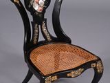 a black chair with a floral design on the back