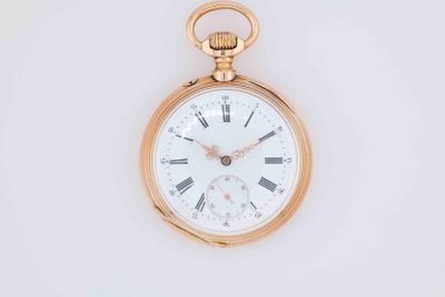 a gold pocket watch with roman numerals on it