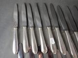 a lot of knives that are sitting on a table