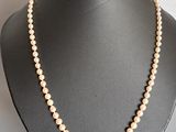 gros plan d'un collier de perles sur un mannequin