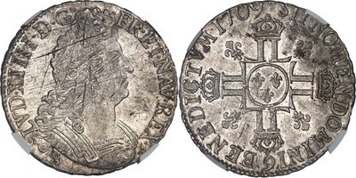 une pièce d'argent sur laquelle figurent l'effigie d'une femme et une croix