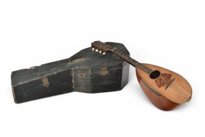 a guitar and a case on a white surface