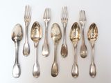 five forks and five spoons arranged in a row