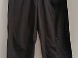 a black pants hanging on a hanger in a room