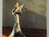 an old book with a figurine of a woman holding a knife