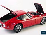 a red toy car with its hood open on a white background