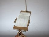 a gold medal hanging from a gold chain on a white table
