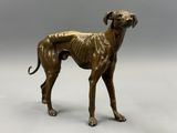 an image of a bronze statue of a dog on a gray background