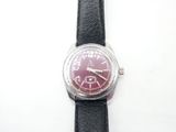 a close up of a wrist watch on a white surface