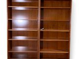 an image of a wooden bookcase with two doors open