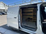 a white van parked in a parking lot next to a building