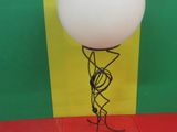 a balloon that is attached to a stand on the floor