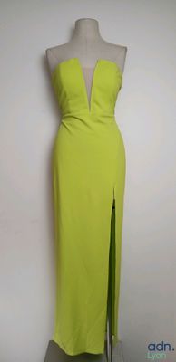 the dress is yellow and has a slit on the side