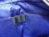 a close up of a blue jacket with black zippers