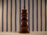 a lamp that is sitting on a table in front of a striped wall