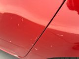 a close up of a red car ' s door handle