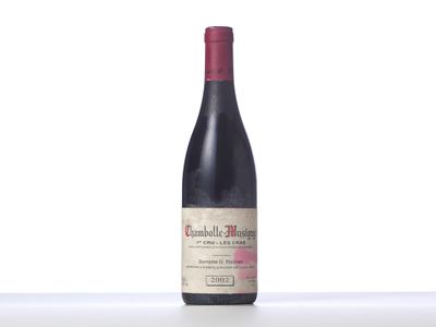 the bottle of red wine is sitting on the table