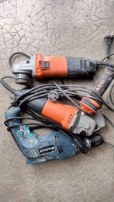 two electric tools laying on the floor next to each other
