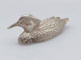 silver plated duck figurine on a white background
