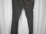 a pair of black pants hanging on a white curtain