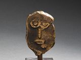bronze head of a man on a wooden stand