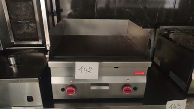 a lot of stainless steel appliances on display in a store