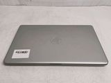 hp laptop computer on a white surface with a sticker on the back