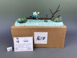 a box with a figurine of a man in a boat on the water