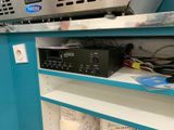 a shelf that has a bunch of electronics on it